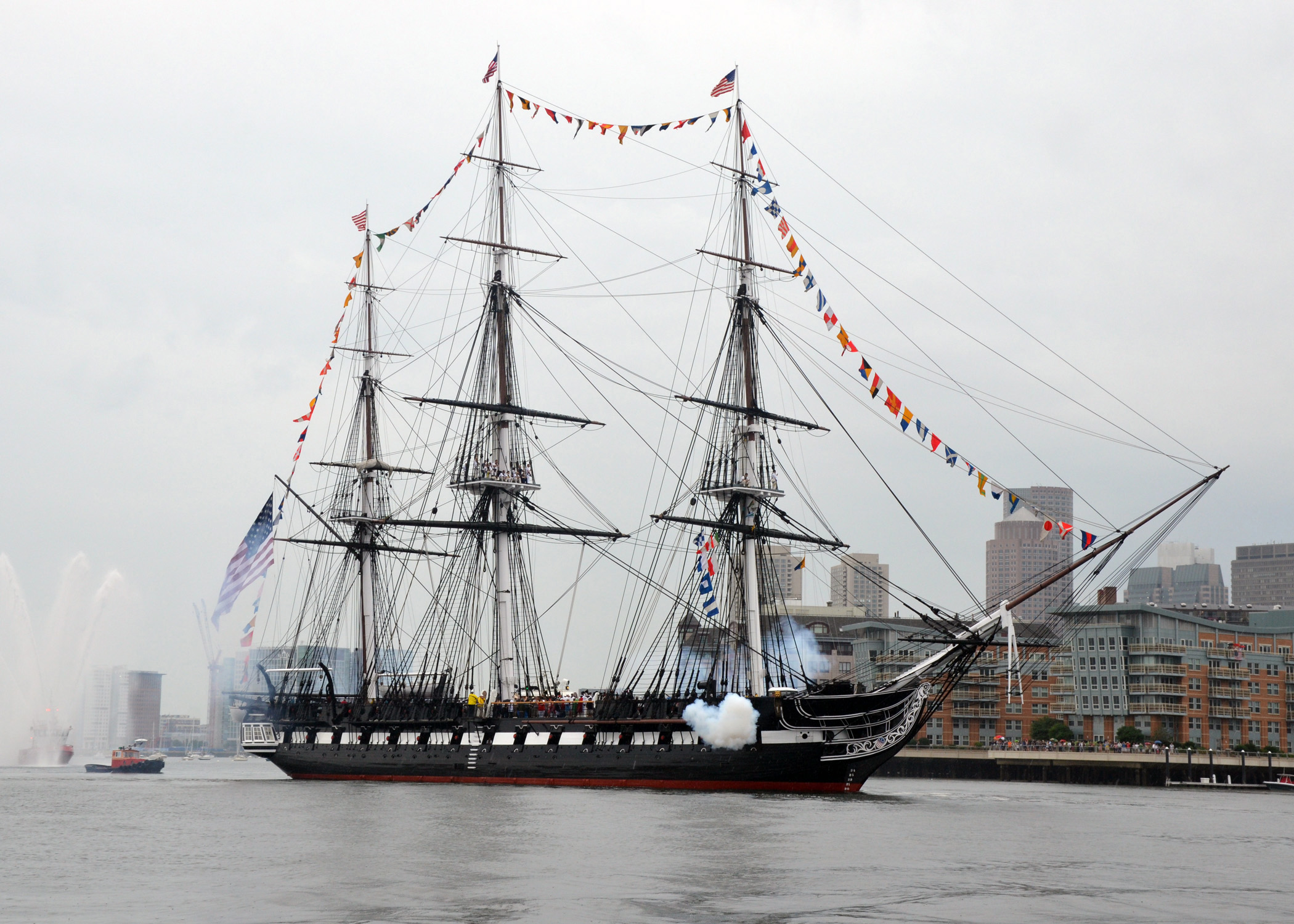 USS Constitution firing a salute while underway in Boston Harbor on Independence Day