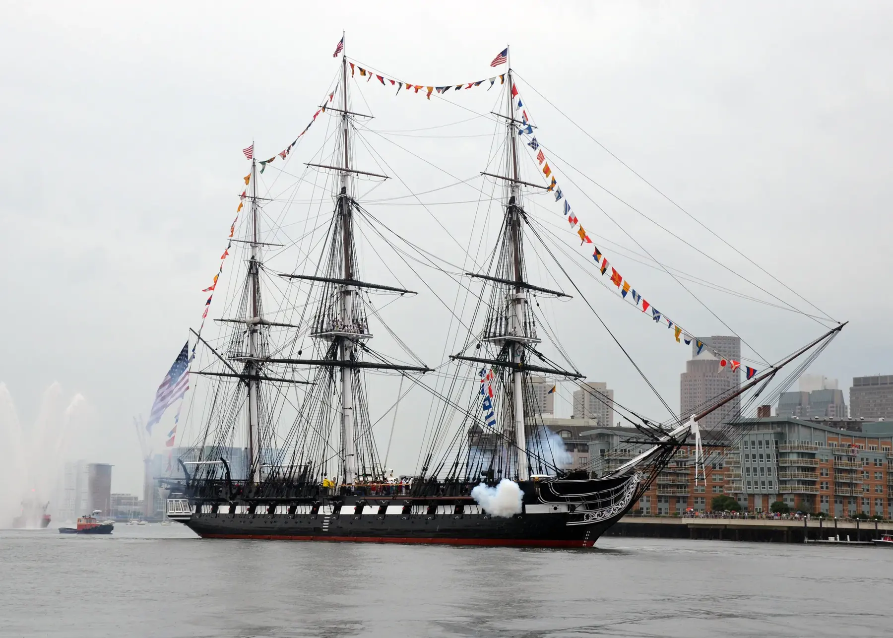 USS Constitution firing a salute while underway in Boston Harbor on Independence Day